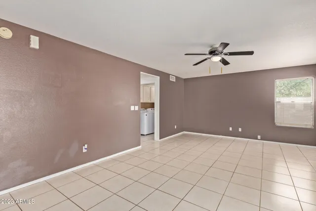 a view of an empty room with a fireplace and a window