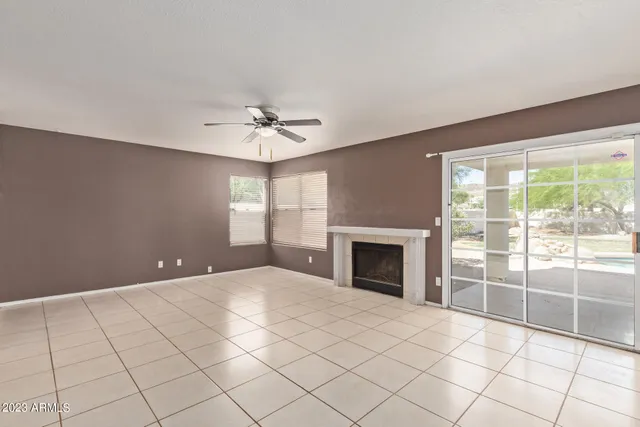 a large white kitchen with granite countertop a refrigerator and a stove top oven