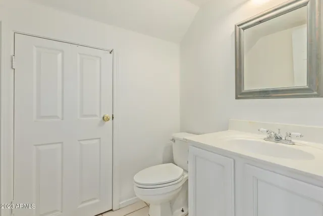 an empty room with a window and a ceiling fan