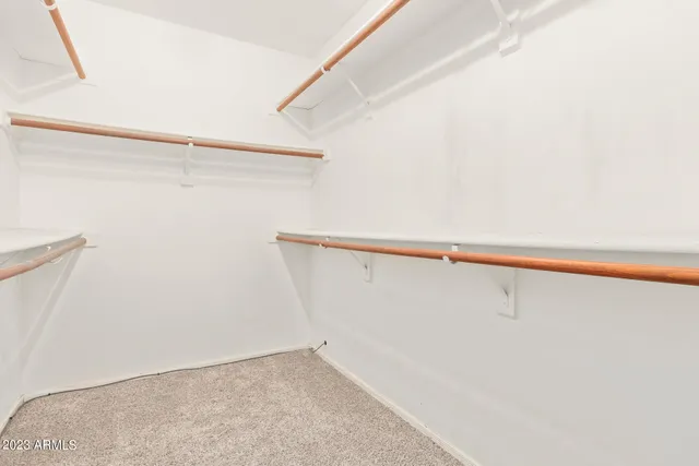 an empty room with a ceiling fan and a window