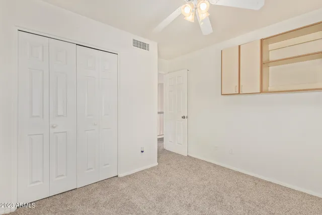 an empty room with windows and closet