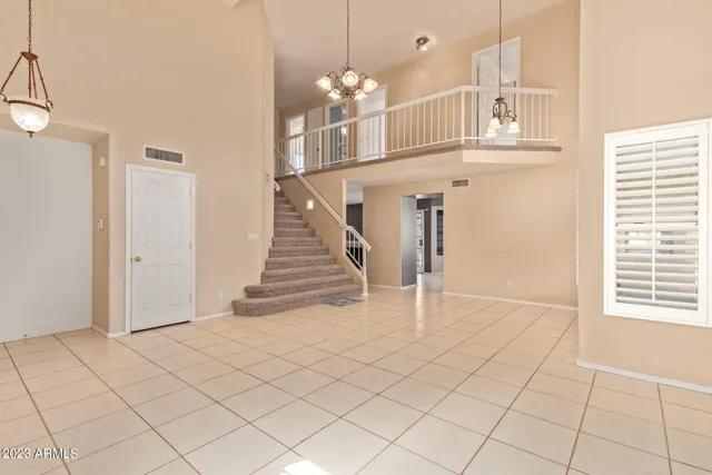 a view of a livingroom with wooden floor and entryway