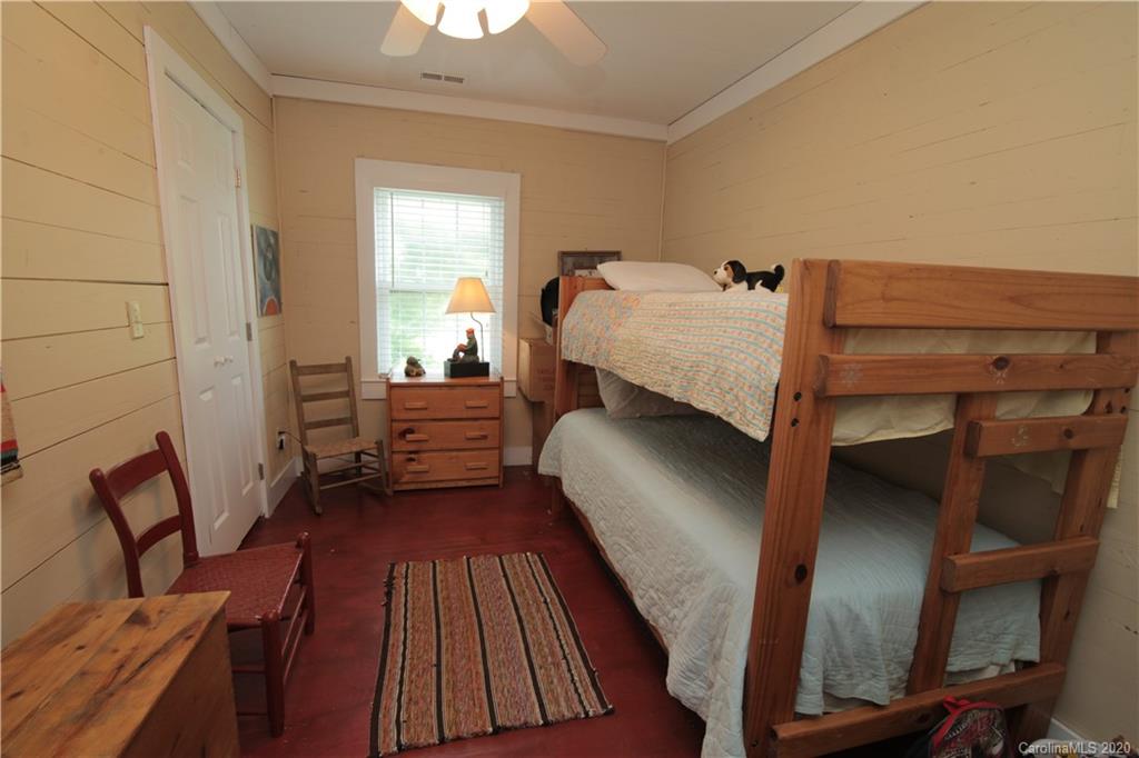 15 Big Level Road Mill Spring, NC 28756 - Photo 14 of 20 a bedroom with a bed and wooden floor