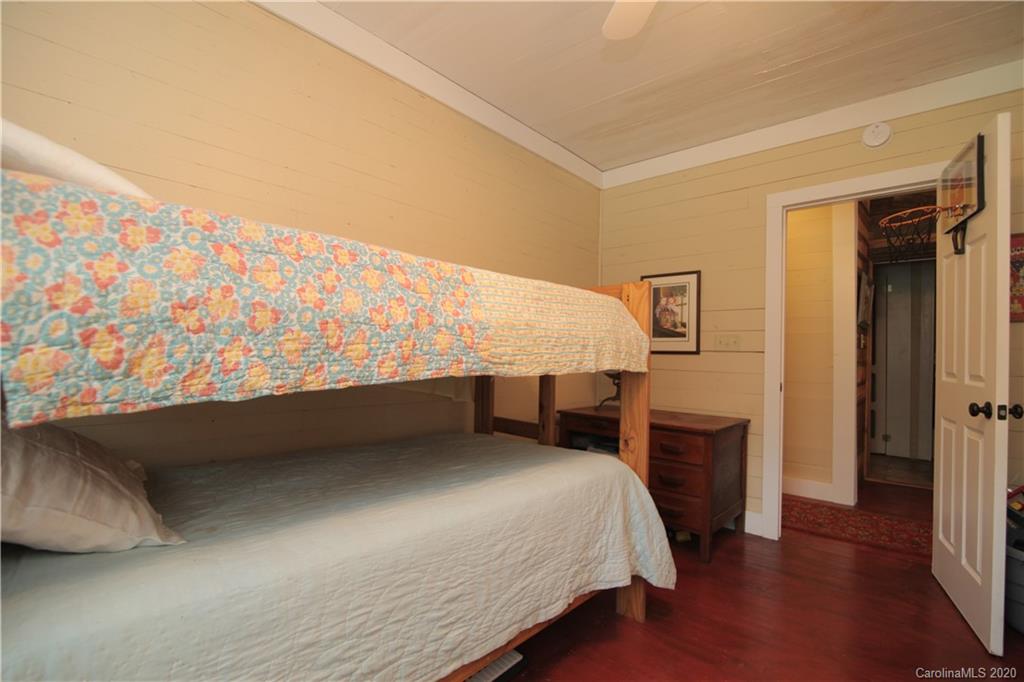 15 Big Level Road Mill Spring, NC 28756 - Photo 15 of 20 a bedroom with a bed and a window