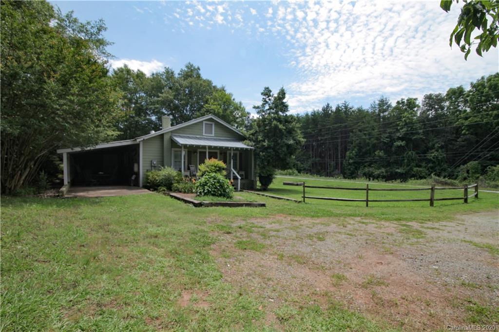 15 Big Level Road Mill Spring, NC 28756 - Photo 18 of 20 a view of a house with backyard and trees