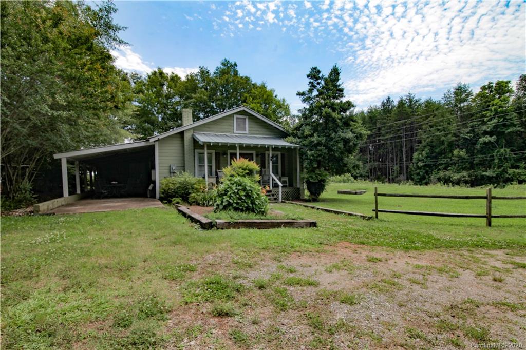 15 Big Level Road Mill Spring, NC 28756 - Photo 20 of 20 a view of a house with backyard and a garden