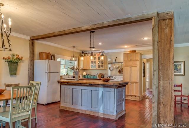 15 Big Level Road Mill Spring, NC 28756 - Photo 5 of 20 a kitchen with a refrigerator and countertop wooden cabinets