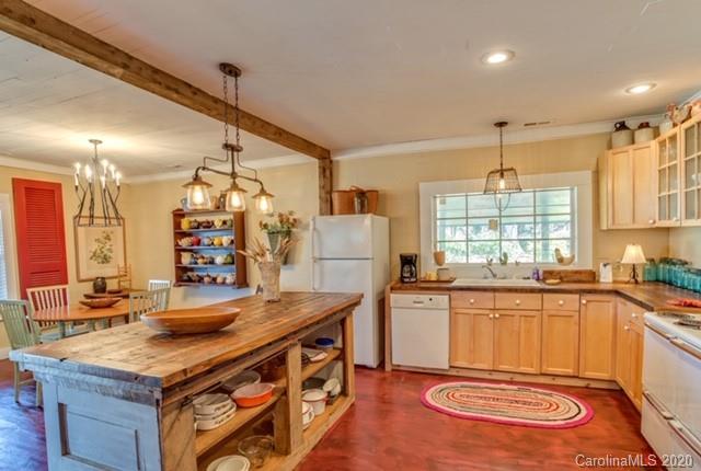 15 Big Level Road Mill Spring, NC 28756 - Photo 6 of 20 a kitchen with stainless steel appliances granite countertop a sink stove and cabinets
