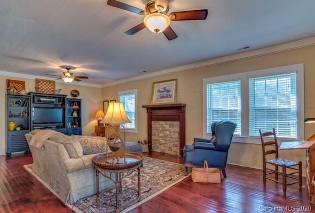 15 Big Level Road Mill Spring, NC 28756 - Photo 8 of 20 a living room with fireplace furniture and a large window