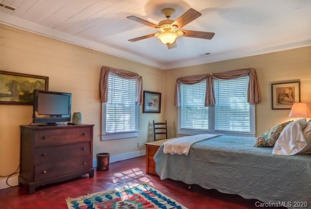 15 Big Level Road Mill Spring, NC 28756 - Photo 10 of 20 a bedroom with a bed and a flat tv screen on dresser