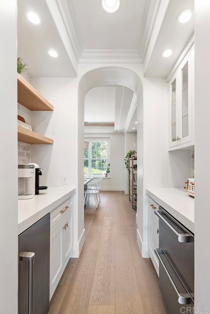 8 Corte Vizcaya San Clemente, CA 92673 - Photo 11 of 62 a kitchen with a sink dishwasher stove and white cabinets with wooden floor