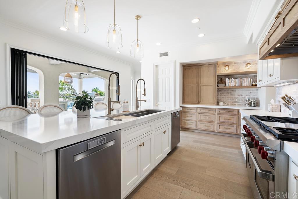 8 Corte Vizcaya San Clemente, CA 92673 - Photo 13 of 62 a kitchen with kitchen island a sink stove and cabinets