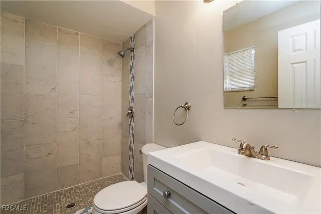 a bathroom with a sink toilet and shower