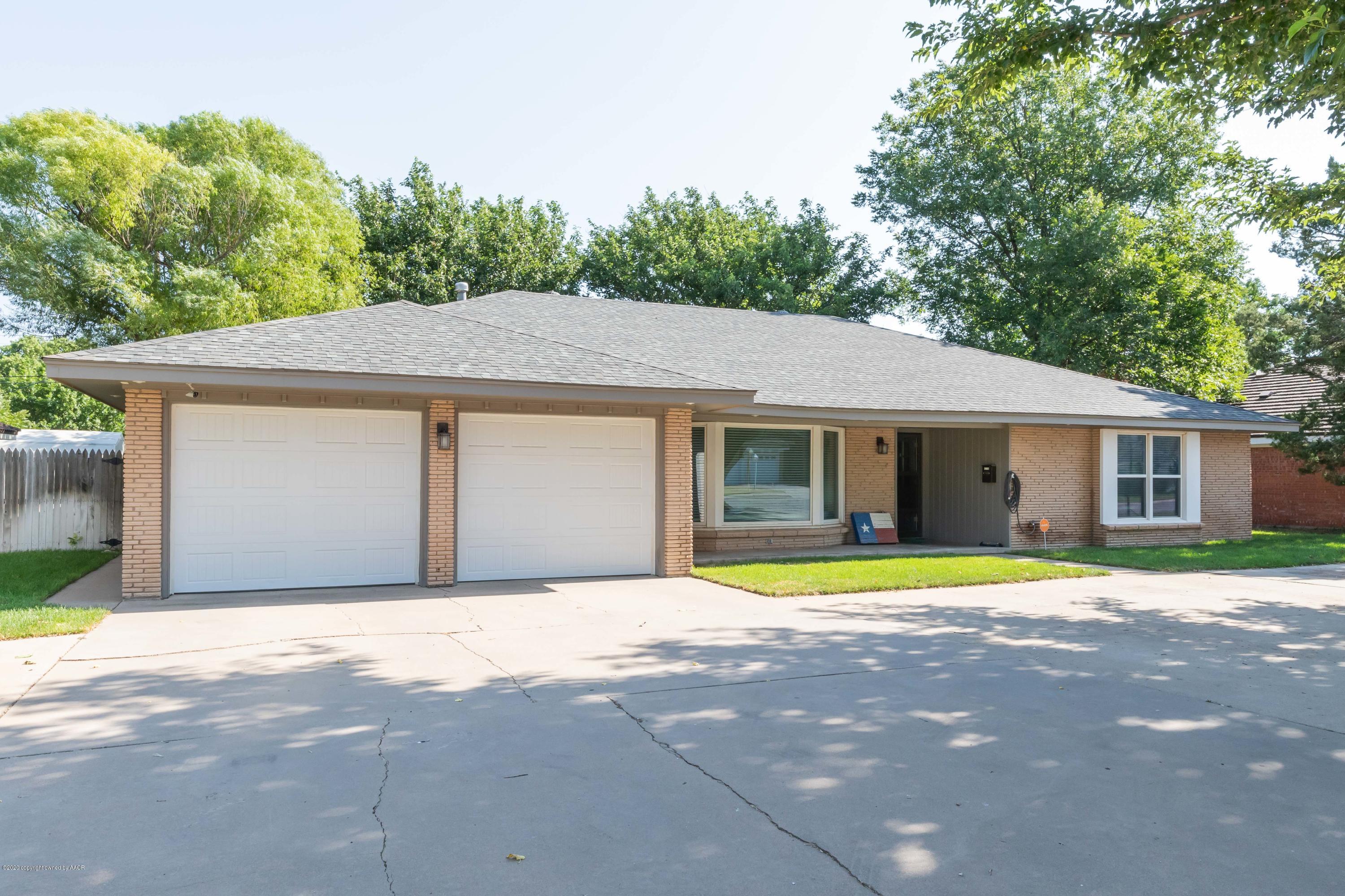 6710 Jameson Road Amarillo, TX 79106 - Photo 1 of 40 a front view of a house with a garden and trees