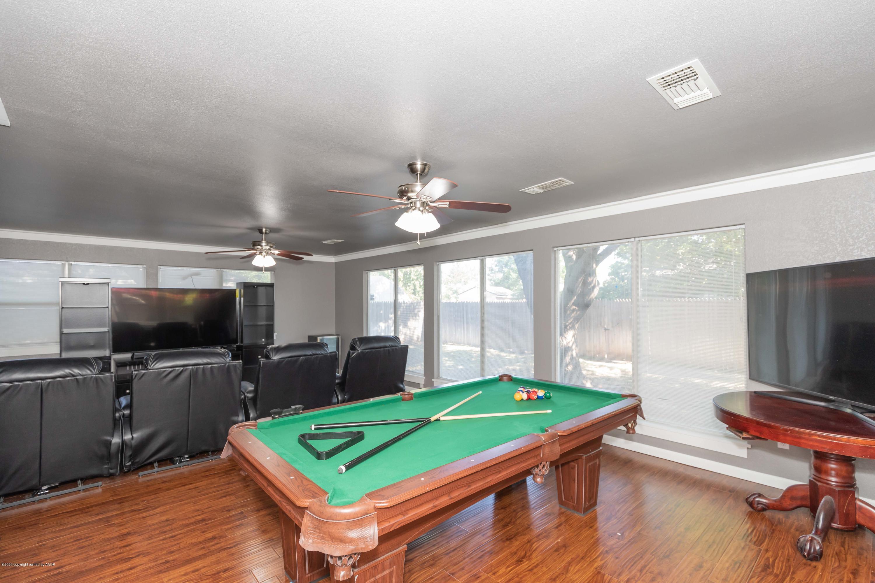 6710 Jameson Road Amarillo, TX 79106 - Photo 19 of 40 a room with pool table flat screen tv and windows