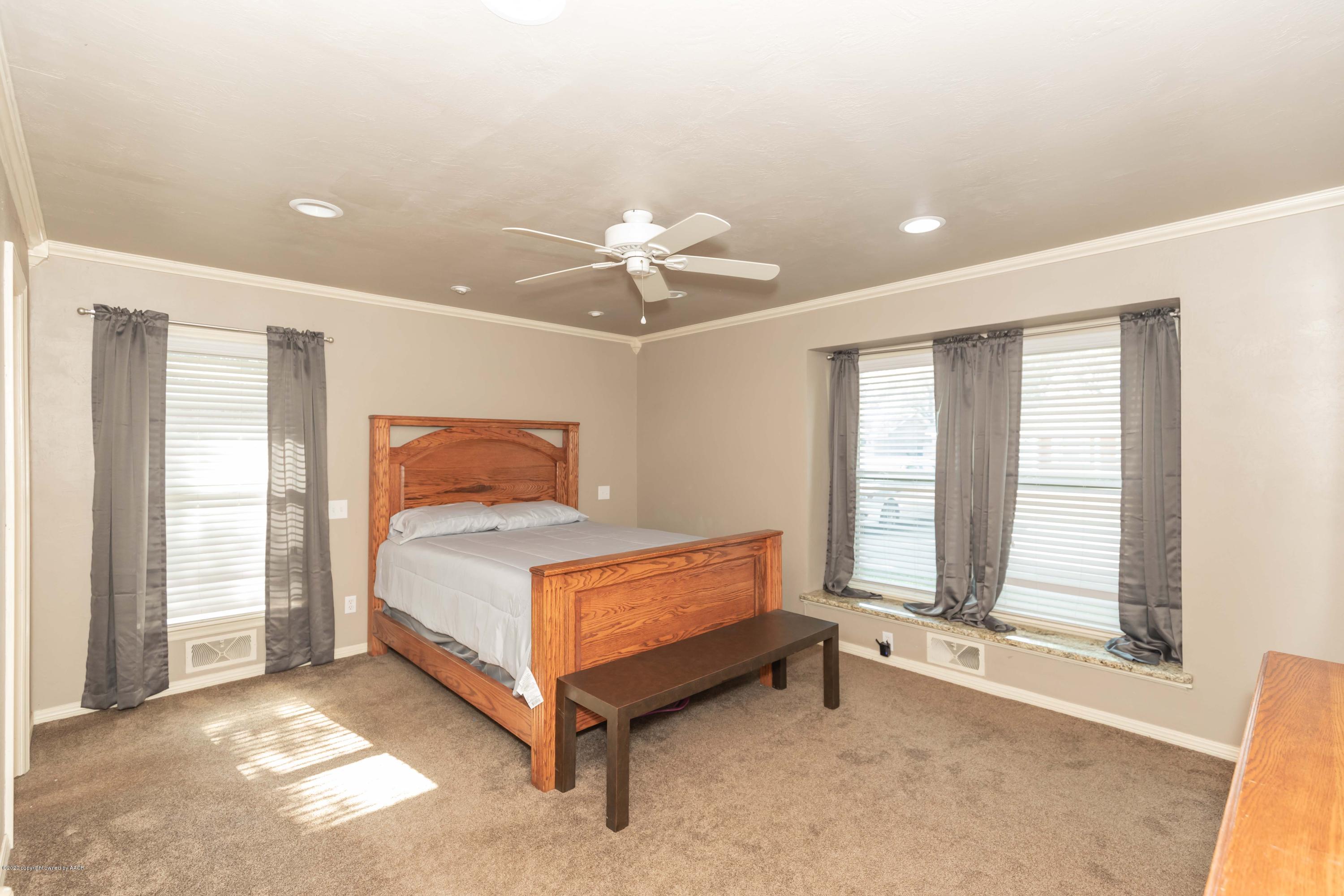 6710 Jameson Road Amarillo, TX 79106 - Photo 21 of 40 a bedroom with a bed and window