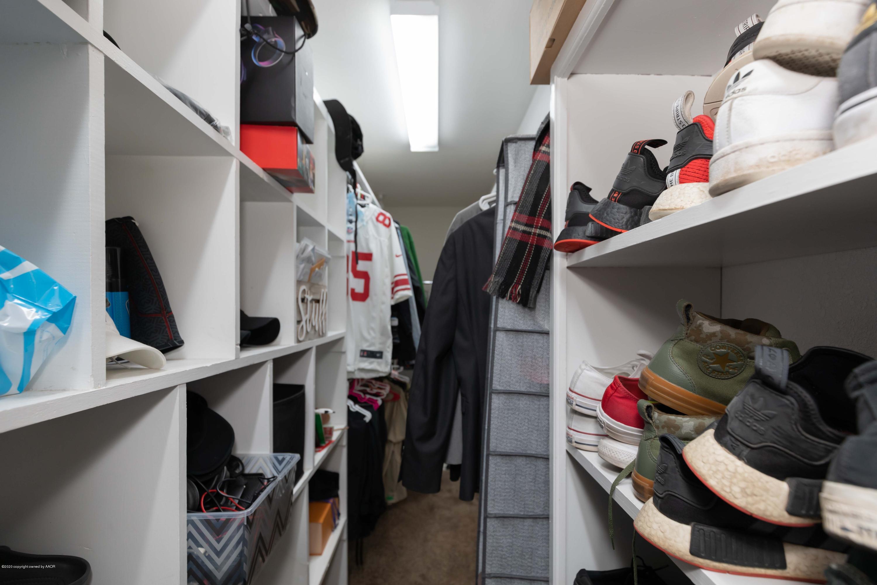 6710 Jameson Road Amarillo, TX 79106 - Photo 27 of 40 a view of walk in closet with clothes and shoes