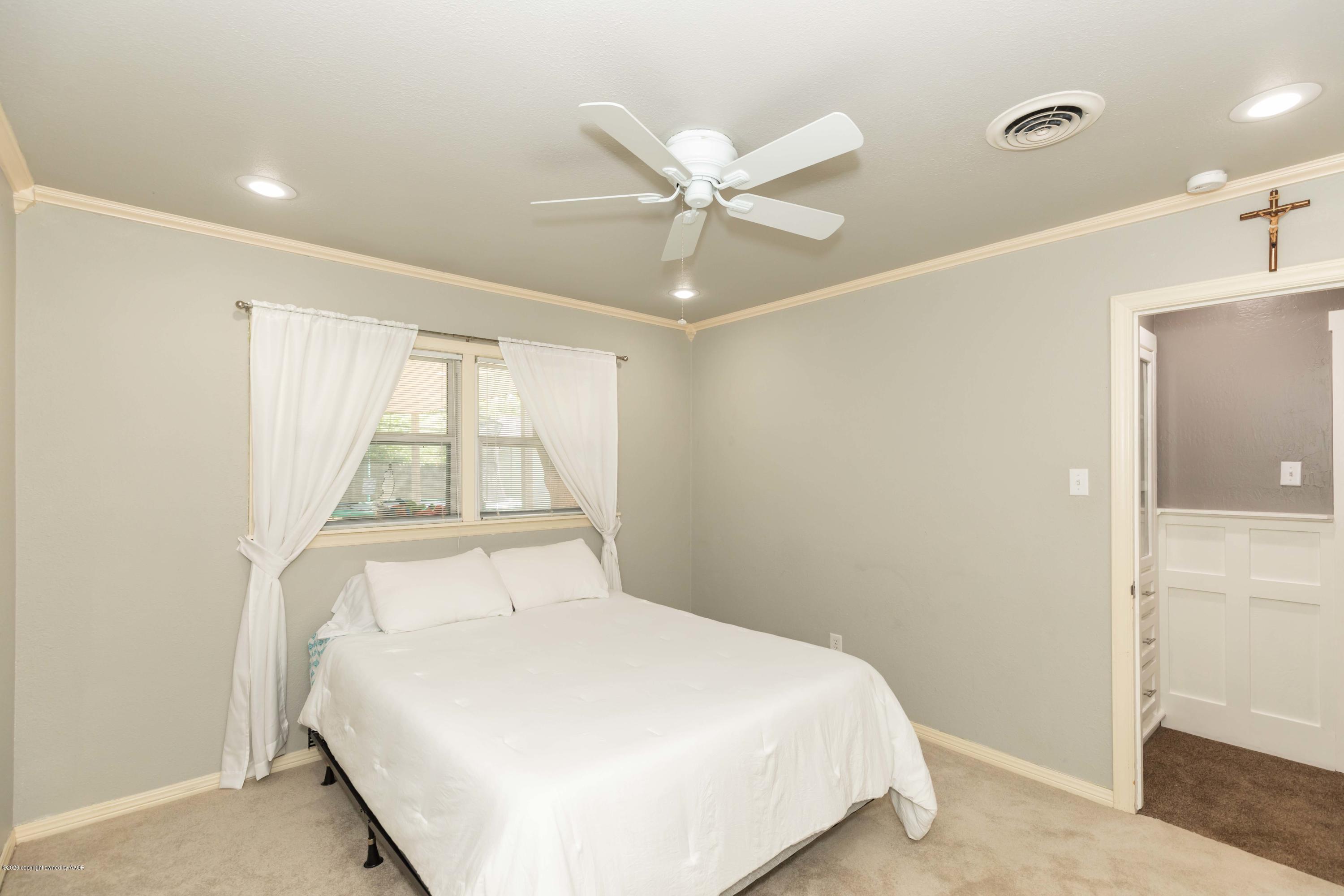 6710 Jameson Road Amarillo, TX 79106 - Photo 28 of 40 a large white bed in a white room next to a window