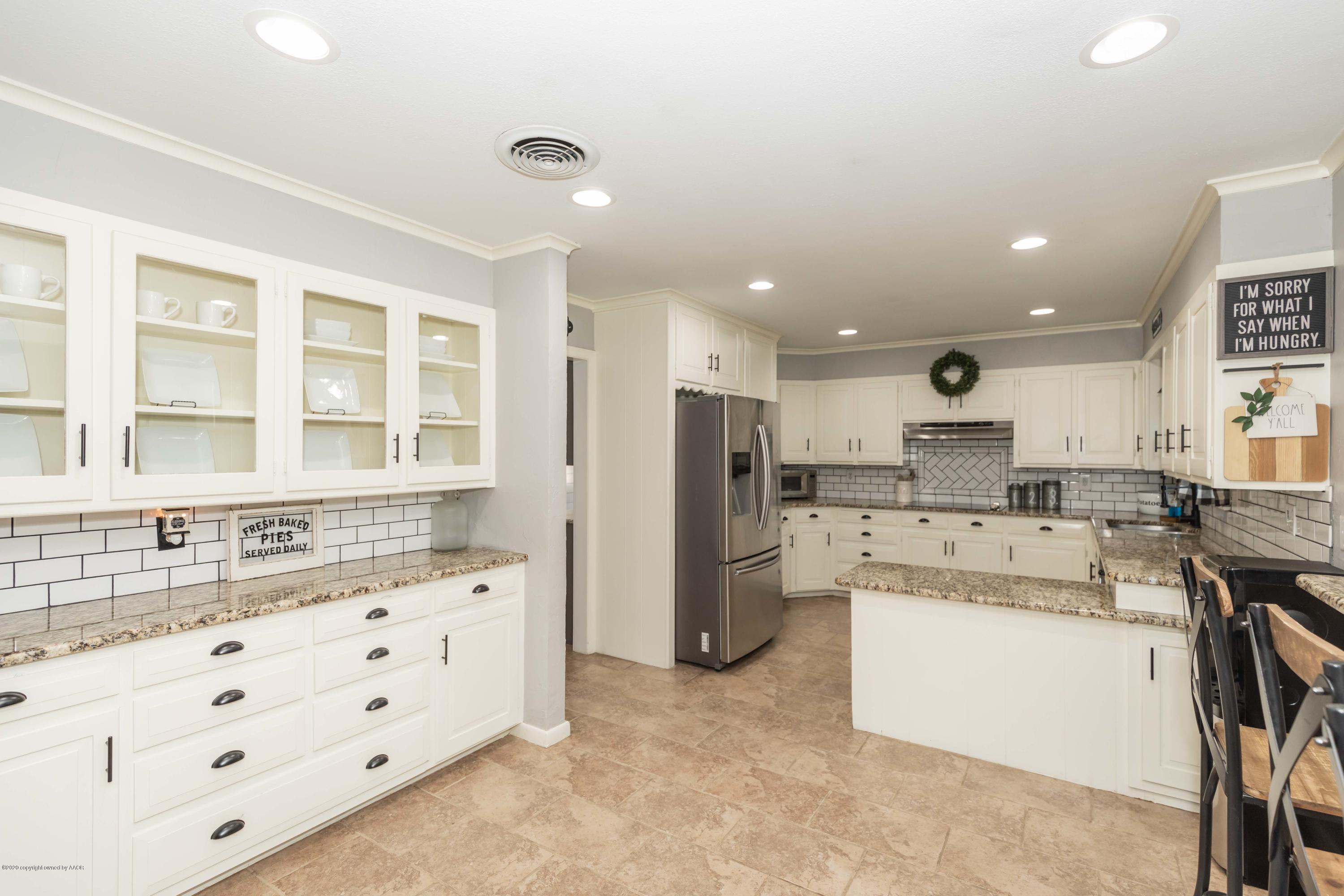 6710 Jameson Road Amarillo, TX 79106 - Photo 5 of 40 a kitchen with refrigerator and cabinets