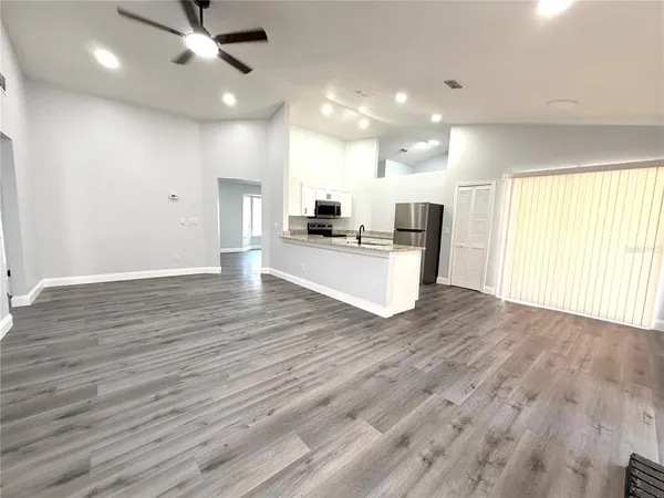 a view of a kitchen with a sink and a microwave