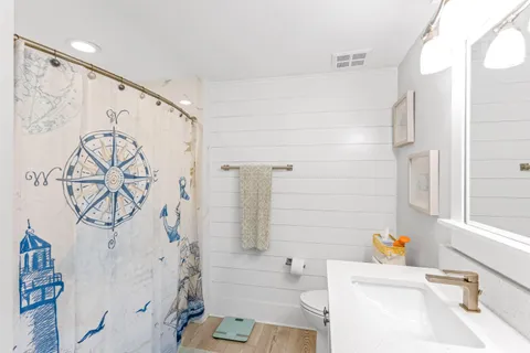 a front view of a house with wooden floor and windows