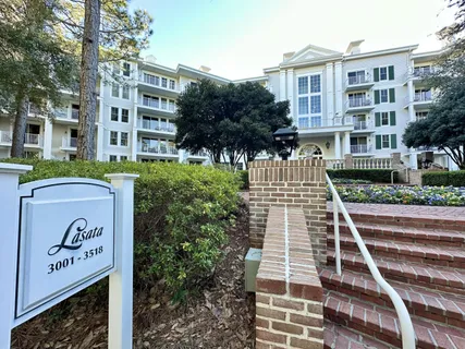 a front view of a residential apartment building with a yard