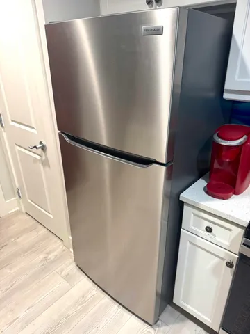 a kitchen with stainless steel appliances a refrigerator and a stove