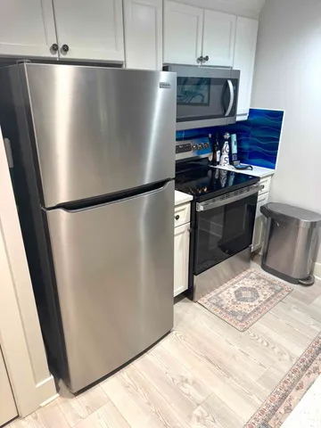 a stove top oven sitting inside of a kitchen