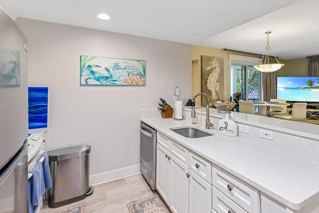 a kitchen with a sink and a stove top oven