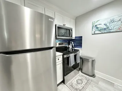 a view of a dining room with furniture a chandelier and wooden floor