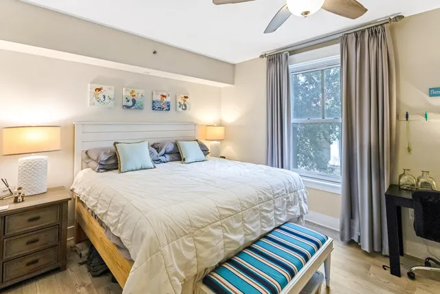 a bedroom with bed and wooden floor