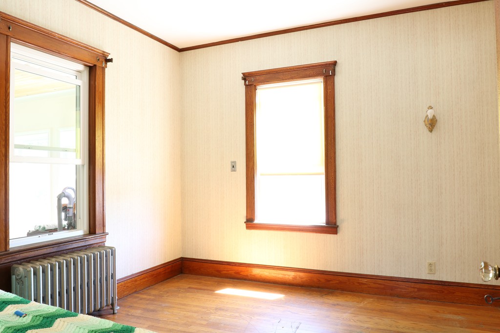 126 Fulton Spring Road Medford, MA 02155 - Photo 8 of 20 an empty room with wooden floor and windows