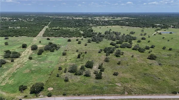 an aerial view of a houses with a yard