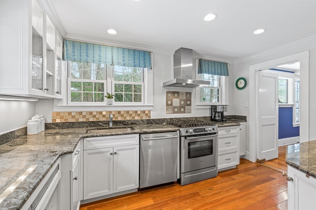 115 Conant Road Weston, MA 02493 - Photo 9 of 31 a kitchen with stainless steel appliances granite countertop a stove and a sink