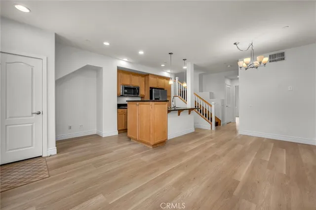 a view of a kitchen with furniture and wooden floor