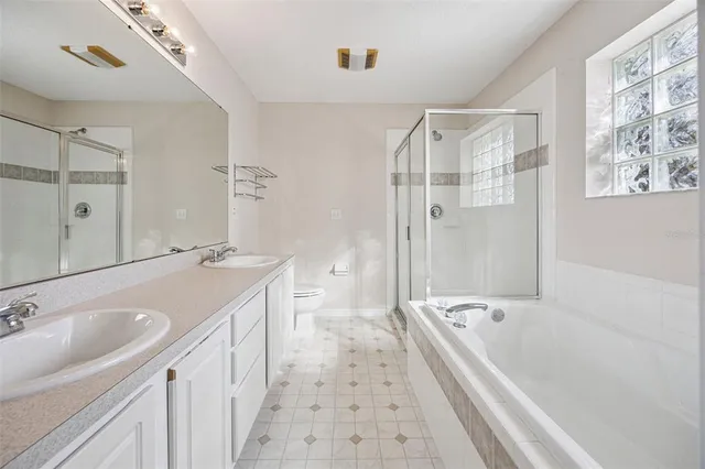 a bathroom with a tub sink and mirror