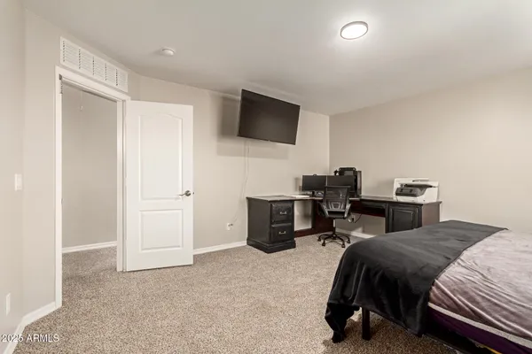 a bedroom with a bed and a television
