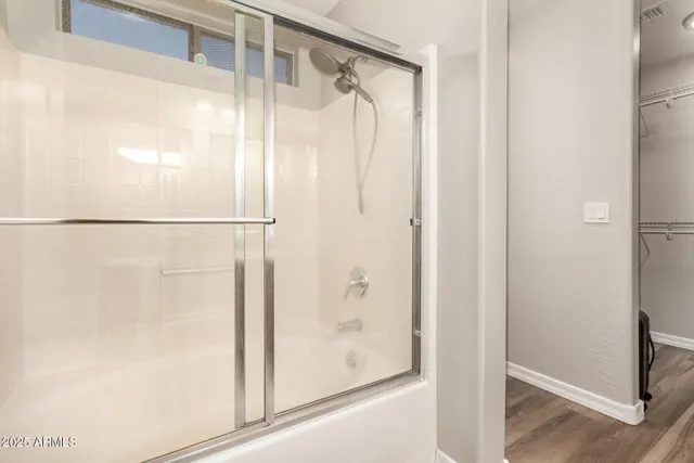 a bathroom with a glass shower door