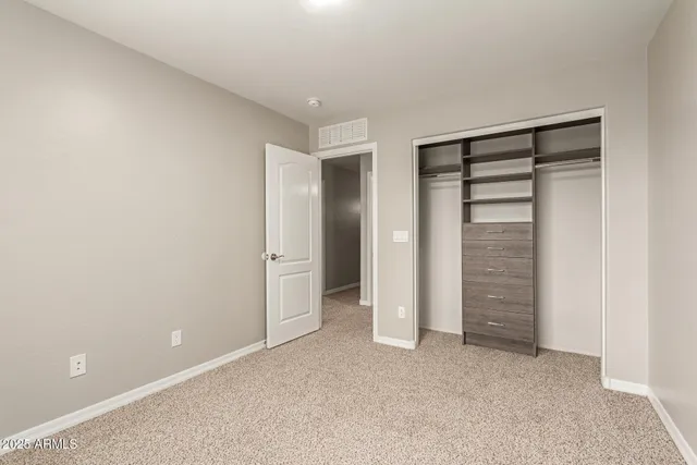 an empty room with closet and closet
