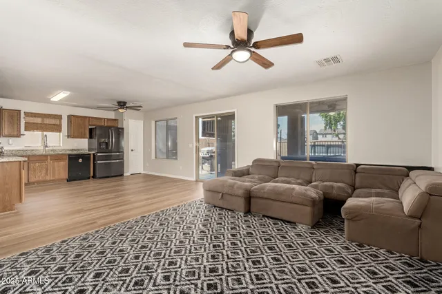 a living room with furniture and kitchen view