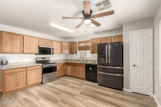 a kitchen with a refrigerator stove and sink