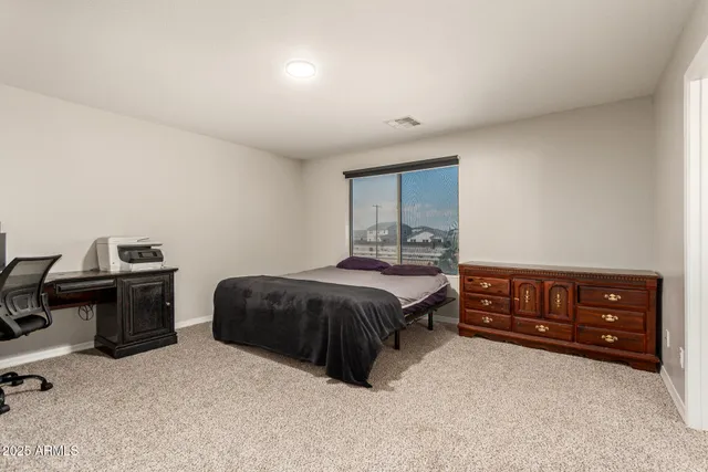 a bedroom with a bed and a dresser