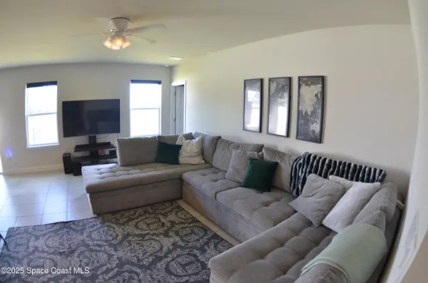 a living room with furniture or couch and a flat screen tv