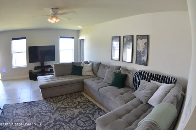 a living room with furniture or couch and a flat screen tv