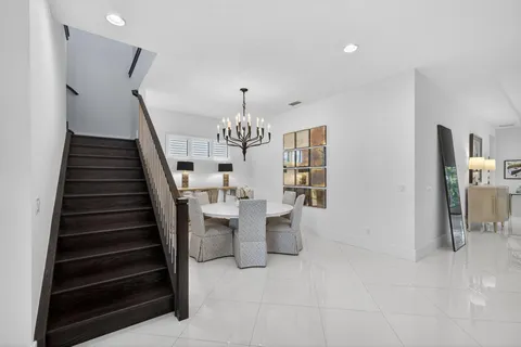 a spacious bedroom with a bed and a chandelier