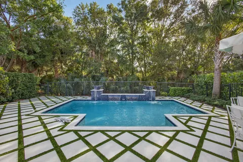 a view of a patio with couches table and chairs and potted plants