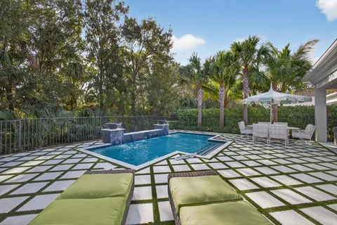 a swimming pool with outdoor seating and yard