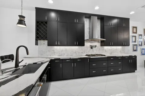 a kitchen with stainless steel appliances kitchen island granite countertop a sink and cabinets