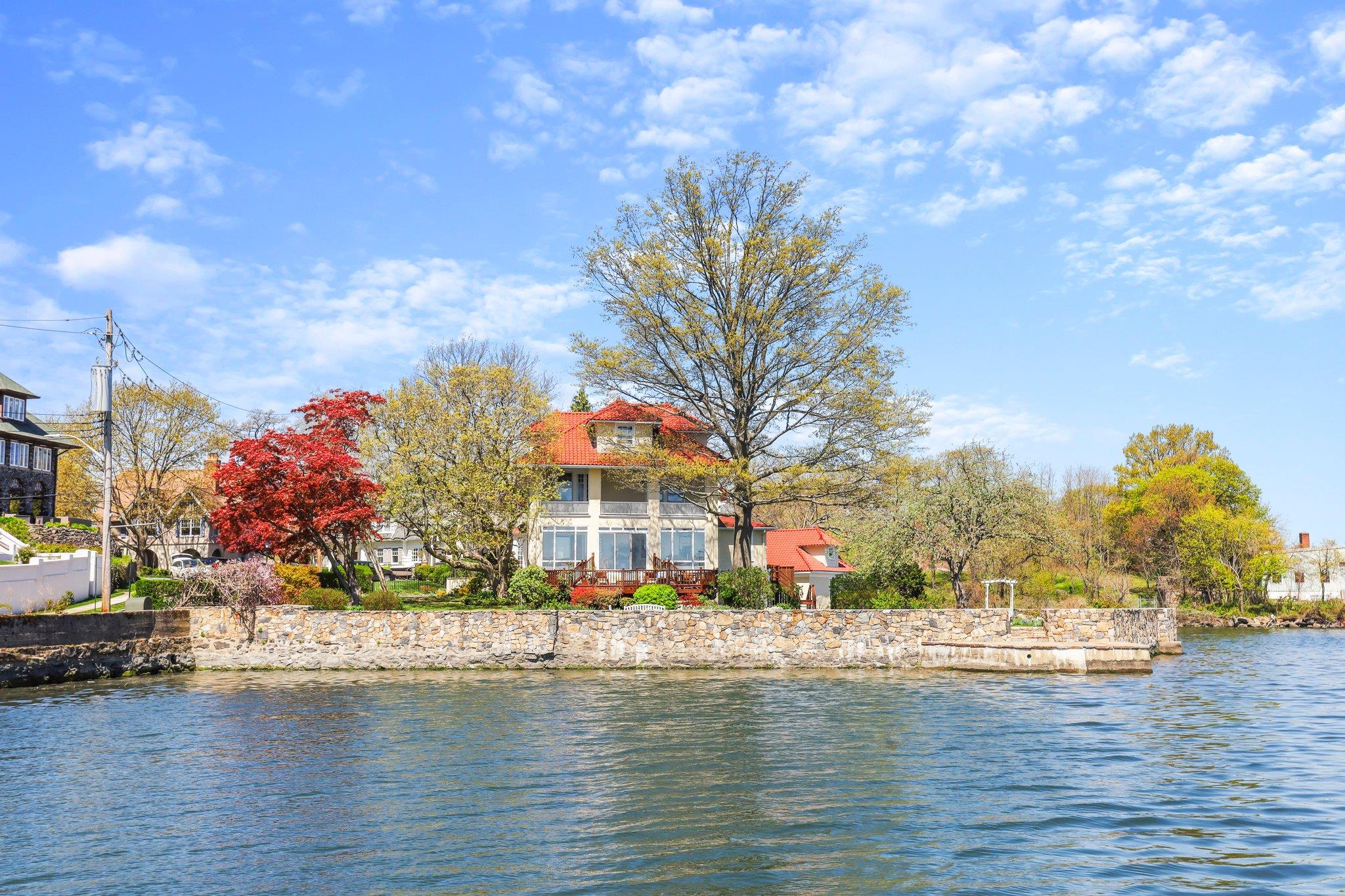 a front view of house with yard and ocean view