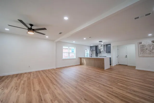 wooden floor in an empty room with a window